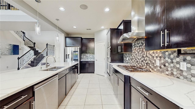4002 Scarlet Branch Rd, Orlando, FL 32824 - kitchen featuring appliances with stainless steel finishes, light stone counters, a sink, decorative light fixtures, and light tile patterned floors