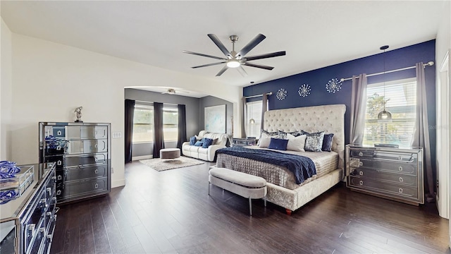 4002 Scarlet Branch Rd, Orlando, FL 32824 - bedroom featuring arched walkways, ceiling fan, and dark wood-style flooring