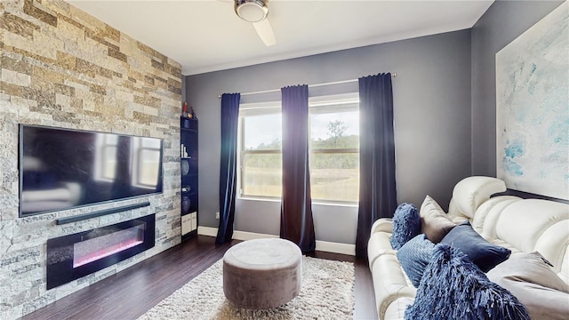 4002 Scarlet Branch Rd, Orlando, FL 32824 - living room featuring dark wood-type flooring, baseboards, a glass covered fireplace, and ceiling fan