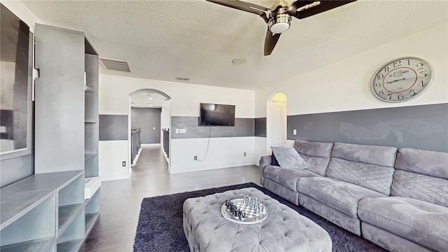 4002 Scarlet Branch Rd, Orlando, FL 32824 - living area featuring arched walkways, ceiling fan, wood finished floors, and visible vents