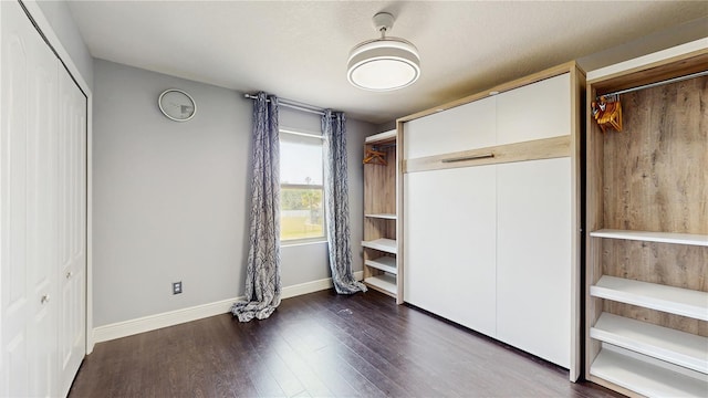 4002 Scarlet Branch Rd, Orlando, FL 32824 - unfurnished bedroom featuring baseboards and dark wood finished floors