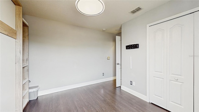 4002 Scarlet Branch Rd, Orlando, FL 32824 - unfurnished bedroom featuring baseboards, visible vents, wood finished floors, and a closet