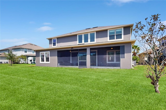 4002 Scarlet Branch Rd, Orlando, FL 32824 - rear view of house with a lawn, stucco siding, and a sunroom