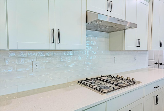 kitchen with stainless steel gas cooktop, white cabinets, and under cabinet range hood