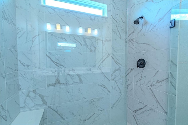 bathroom with a tile shower