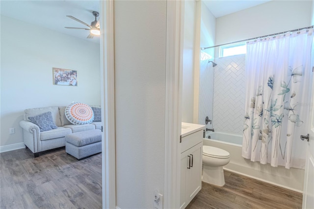 full bath featuring shower / bath combination with curtain, wood finished floors, toilet, vanity, and ceiling fan