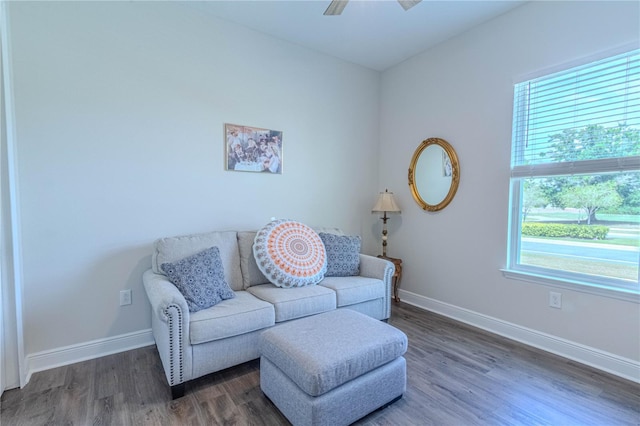 sitting room featuring wood finished floors, a healthy amount of sunlight, a ceiling fan, and baseboards
