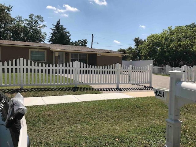 4251 Anthony Ln, Orlando, FL 32822 - view of front of property with stucco siding, a fenced front yard, and a front yard