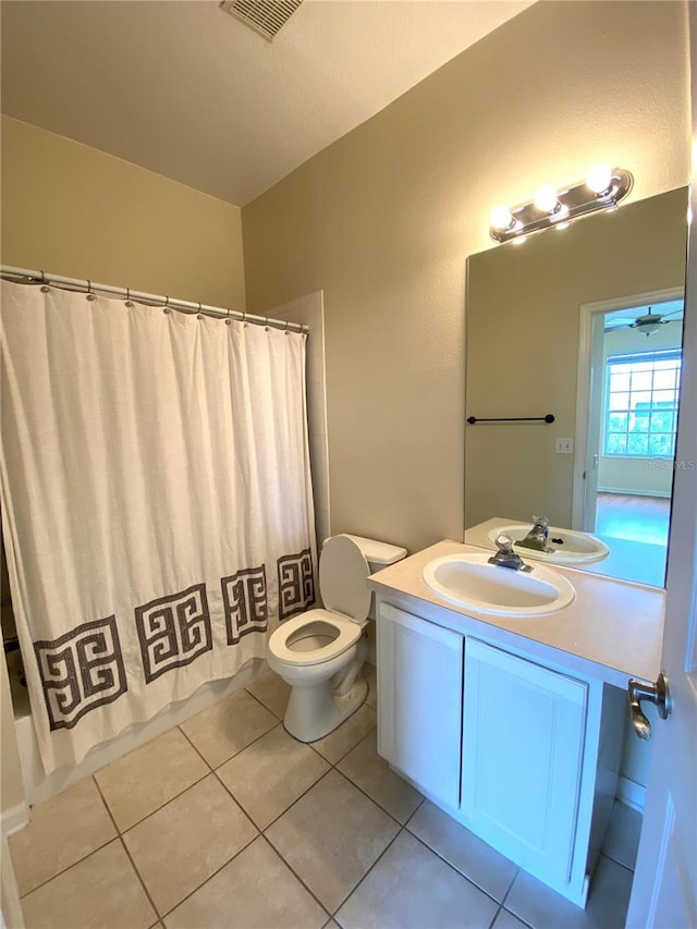 full bath with tile patterned flooring, visible vents, toilet, vanity, and shower / bath combo with shower curtain
