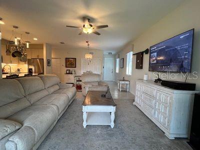 5060 Arancia Ln, Ave Maria, FL 34142 - living room with ceiling fan with notable chandelier