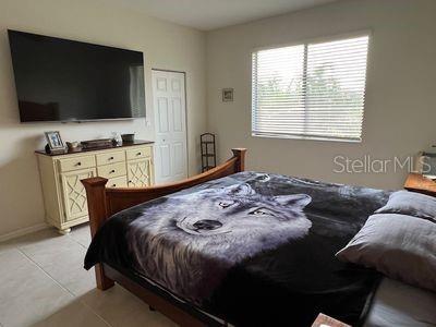 5060 Arancia Ln, Ave Maria, FL 34142 - bedroom with light tile patterned flooring and baseboards