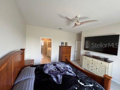 5060 Arancia Ln, Ave Maria, FL 34142 - bedroom with a ceiling fan and ensuite bath