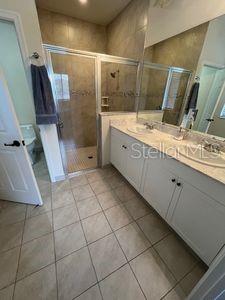 5060 Arancia Ln, Ave Maria, FL 34142 - full bath with tile patterned flooring, double vanity, and a shower stall