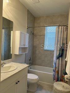 5060 Arancia Ln, Ave Maria, FL 34142 - full bath featuring tile patterned floors, shower / tub combo, toilet, and vanity