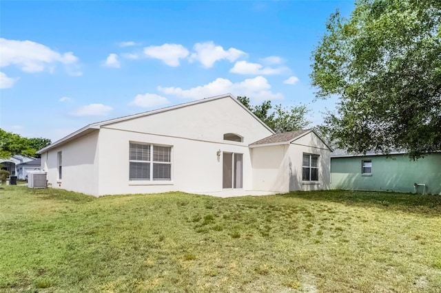 11460 Brown Quail Ct, Orlando, FL 32817 - back of property with a yard, central air condition unit, and stucco siding