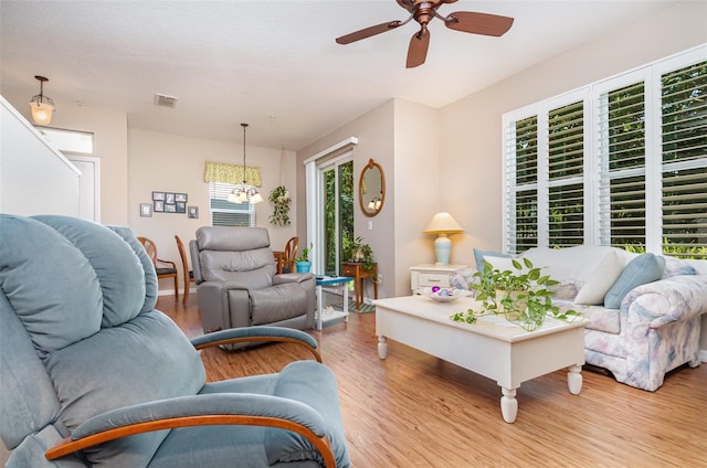 3321 San Jacinto Cir Unit 116, Sanford, FL 32771 - living room with wood finished floors, a ceiling fan, and a chandelier