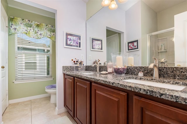 3321 San Jacinto Cir Unit 116, Sanford, FL 32771 - bathroom with toilet, double vanity, a shower stall, baseboards, and tile patterned floors