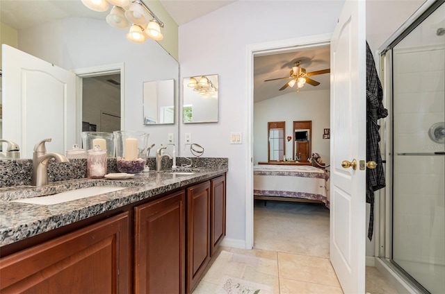 3321 San Jacinto Cir Unit 116, Sanford, FL 32771 - ensuite bathroom featuring lofted ceiling, ceiling fan, double vanity, a tile shower, and tile patterned floors