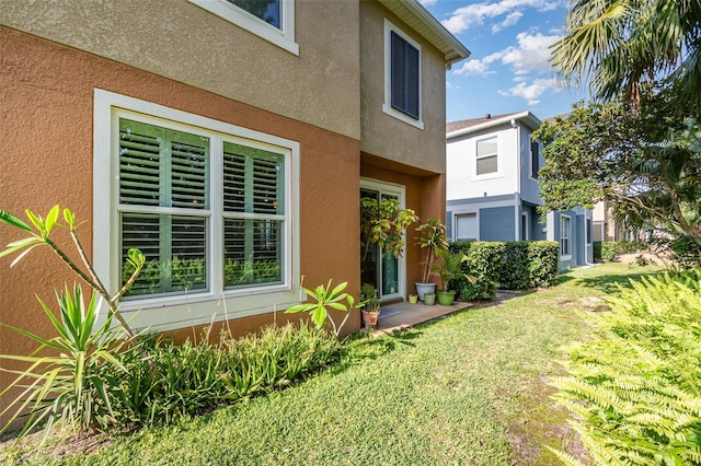 3321 San Jacinto Cir Unit 116, Sanford, FL 32771 - view of property exterior featuring stucco siding and a lawn
