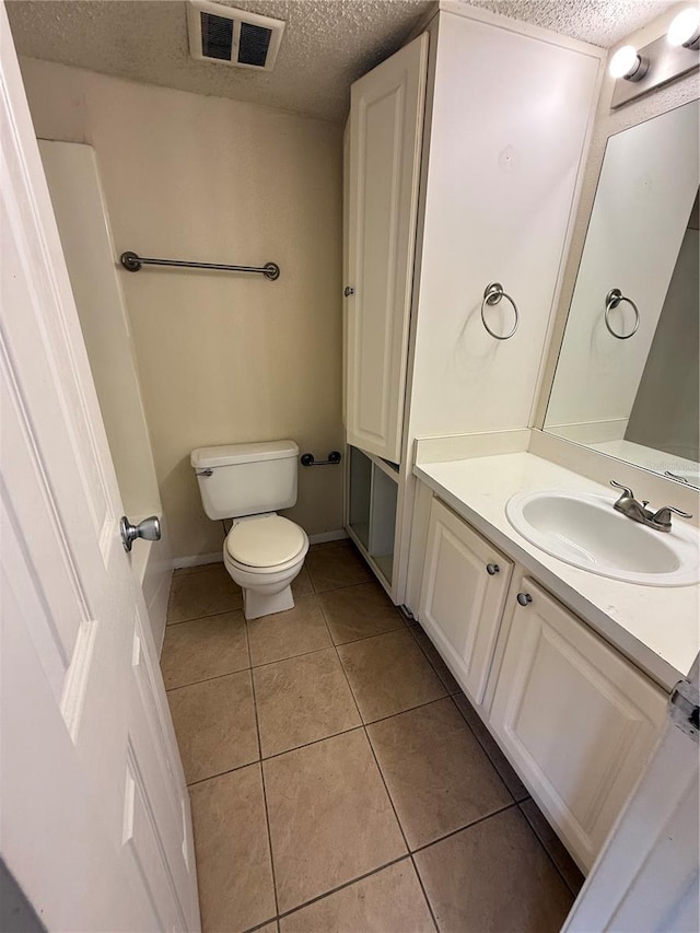 128 Water Front Way Unit 300, Altamonte Springs, FL 32701 - bathroom with vanity, toilet, a textured ceiling, tile patterned floors, and visible vents