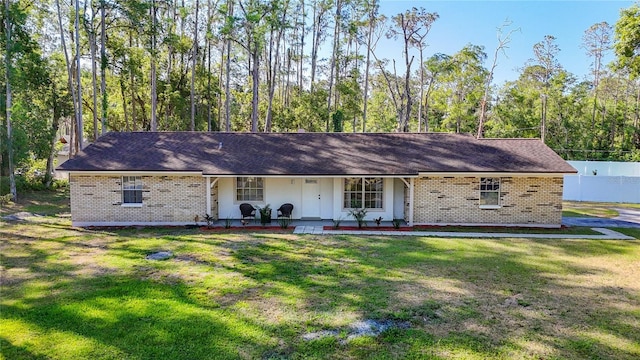 21940 Dupree Dr, Land O Lakes, FL 34639 - ranch-style home with covered porch, brick siding, a shingled roof, and a front yard