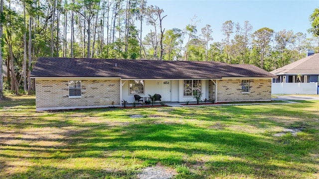 21940 Dupree Dr, Land O Lakes, FL 34639 - view of front facade featuring covered porch, brick siding, and a front yard