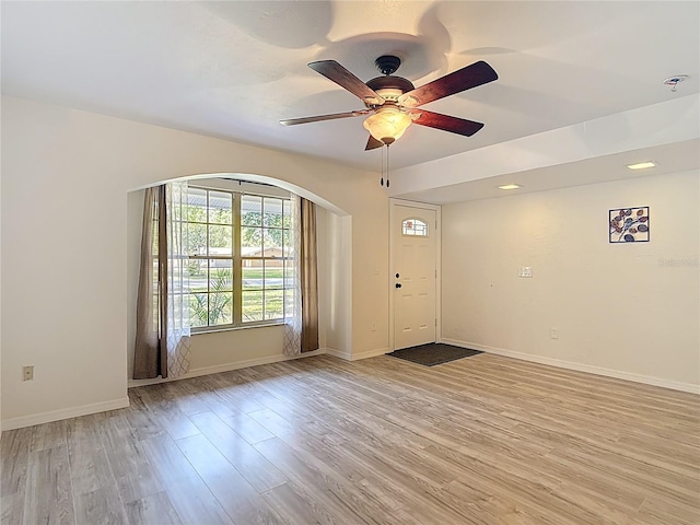 21940 Dupree Dr, Land O Lakes, FL 34639 - entrance foyer featuring light wood-type flooring, arched walkways, baseboards, and a ceiling fan