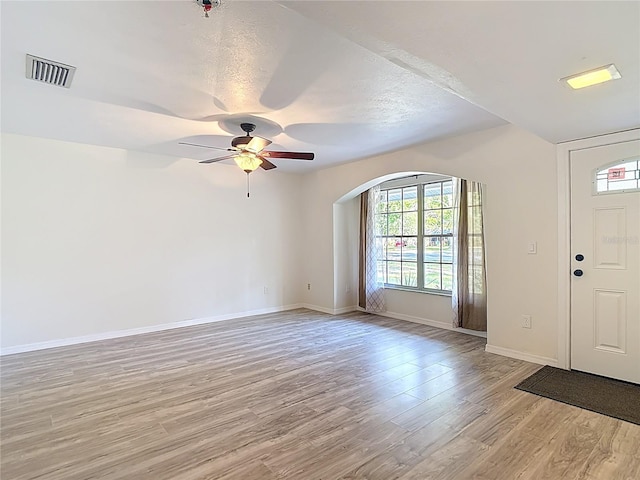 21940 Dupree Dr, Land O Lakes, FL 34639 - foyer entrance with a healthy amount of sunlight, arched walkways, light wood finished floors, and visible vents