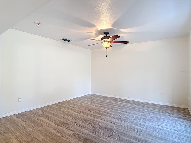 21940 Dupree Dr, Land O Lakes, FL 34639 - empty room featuring visible vents, a ceiling fan, baseboards, and wood finished floors