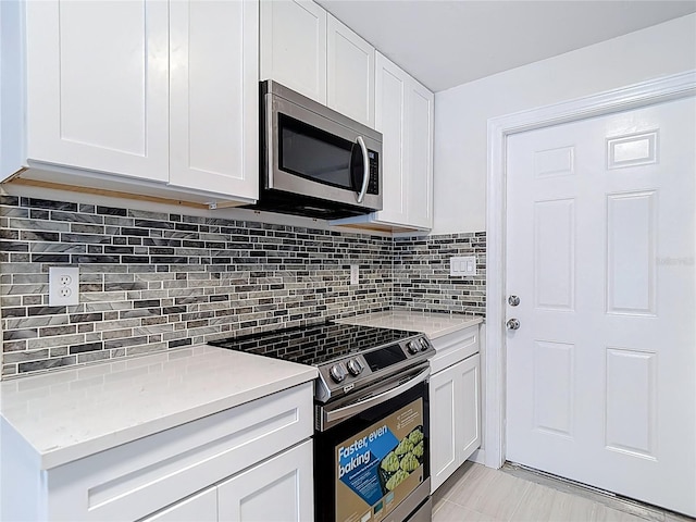 21940 Dupree Dr, Land O Lakes, FL 34639 - kitchen with light countertops, appliances with stainless steel finishes, and white cabinets
