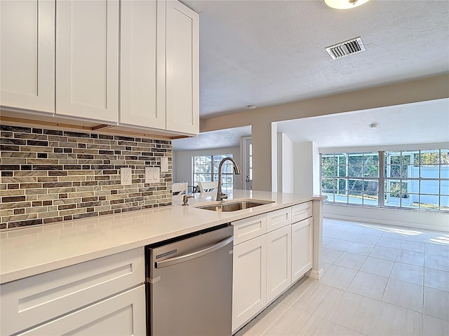 21940 Dupree Dr, Land O Lakes, FL 34639 - kitchen featuring decorative backsplash, visible vents, dishwasher, a sink, and light tile patterned flooring