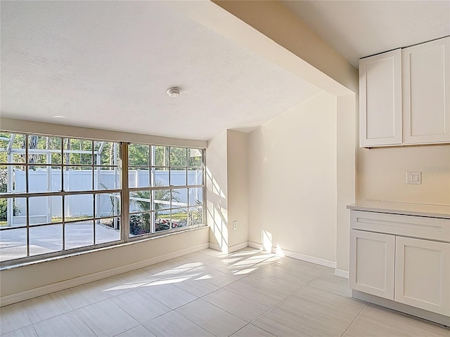 21940 Dupree Dr, Land O Lakes, FL 34639 - unfurnished room featuring a textured ceiling, baseboards, and light tile patterned floors