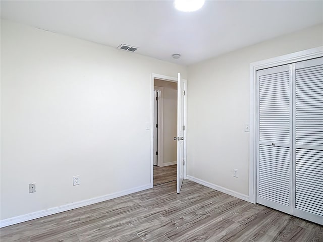 21940 Dupree Dr, Land O Lakes, FL 34639 - unfurnished bedroom featuring baseboards, a closet, light wood finished floors, and visible vents