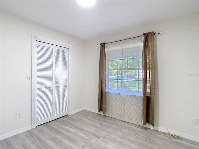 21940 Dupree Dr, Land O Lakes, FL 34639 - spare room featuring baseboards and light wood-style flooring