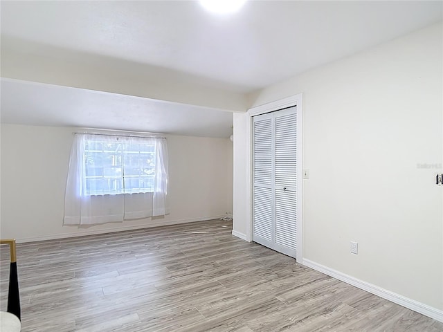 21940 Dupree Dr, Land O Lakes, FL 34639 - unfurnished bedroom with baseboards, a closet, and light wood-type flooring