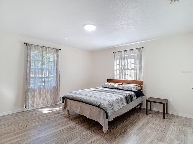 21940 Dupree Dr, Land O Lakes, FL 34639 - bedroom with light wood-style floors and baseboards