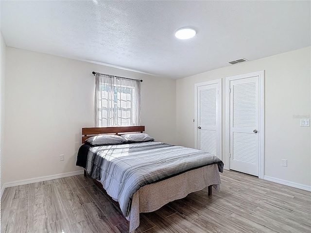 21940 Dupree Dr, Land O Lakes, FL 34639 - bedroom with baseboards, visible vents, and light wood-type flooring