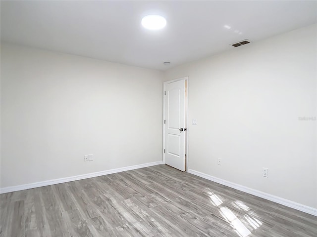 21940 Dupree Dr, Land O Lakes, FL 34639 - spare room with baseboards, wood finished floors, and visible vents