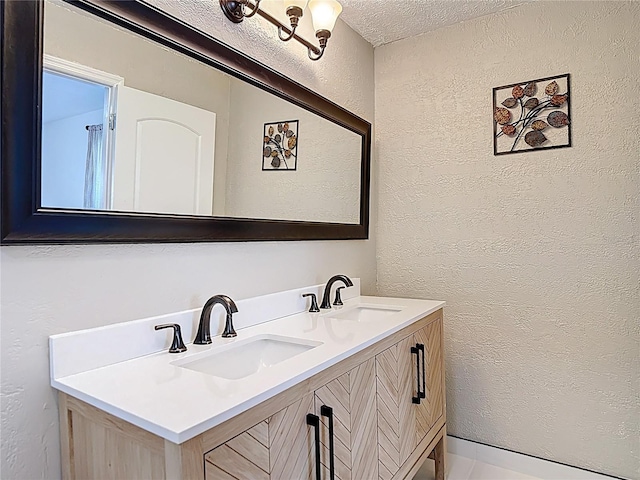 21940 Dupree Dr, Land O Lakes, FL 34639 - bathroom featuring double vanity, a textured wall, a sink, and a textured ceiling