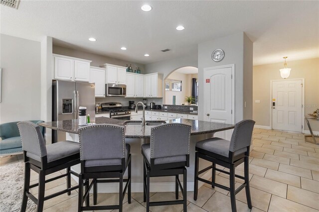 4201 Oakview Dr, Davenport, FL 33837 - kitchen with visible vents, a sink, appliances with stainless steel finishes, and a kitchen bar