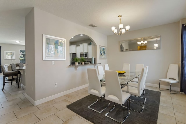 4201 Oakview Dr, Davenport, FL 33837 - dining room with visible vents, arched walkways, light tile patterned floors, baseboards, and a chandelier