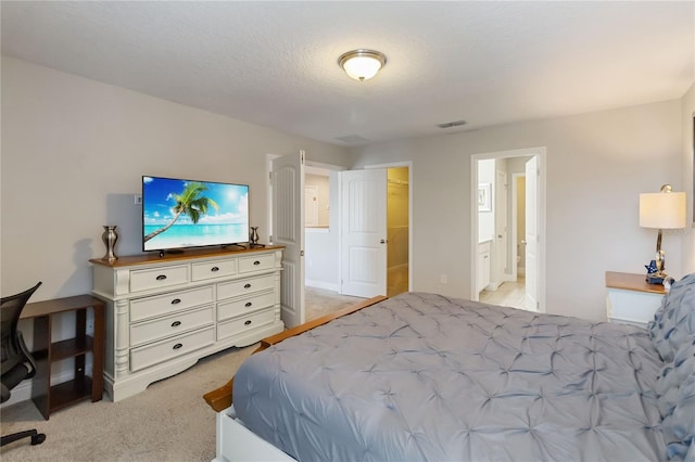 4201 Oakview Dr, Davenport, FL 33837 - bedroom with visible vents, ensuite bath, and light colored carpet