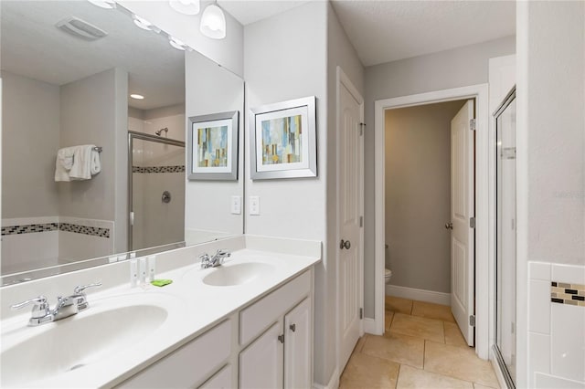 4201 Oakview Dr, Davenport, FL 33837 - bathroom with a sink, a shower stall, toilet, and visible vents