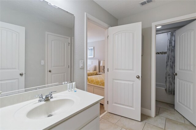 4201 Oakview Dr, Davenport, FL 33837 - ensuite bathroom featuring tile patterned floors, vanity, connected bathroom, and visible vents