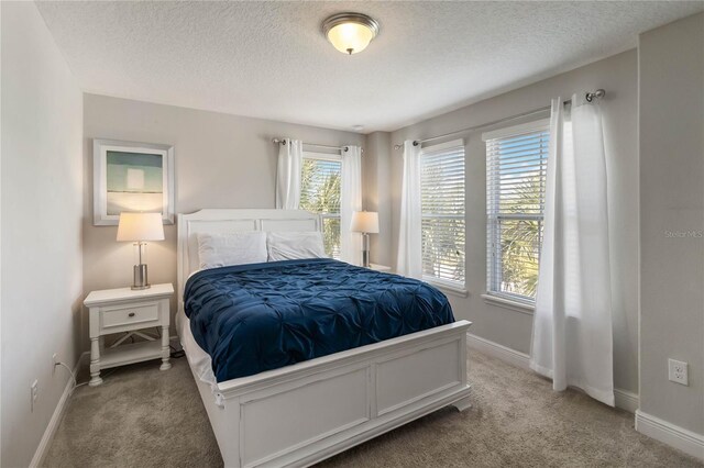4201 Oakview Dr, Davenport, FL 33837 - bedroom featuring baseboards, carpet flooring, and a textured ceiling