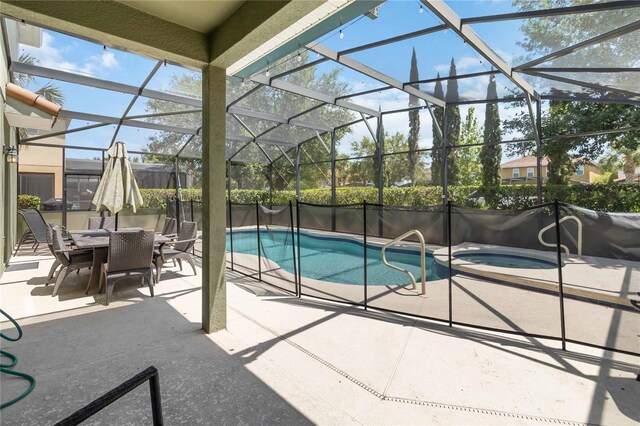 4201 Oakview Dr, Davenport, FL 33837 - view of pool with glass enclosure, outdoor dining area, a pool with connected hot tub, and a patio area