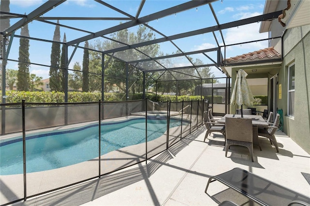 4201 Oakview Dr, Davenport, FL 33837 - view of swimming pool featuring a lanai, a pool with connected hot tub, a patio area, and outdoor dining space