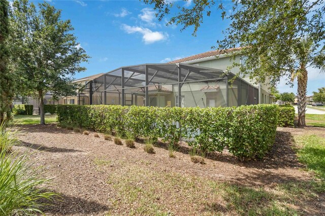 4201 Oakview Dr, Davenport, FL 33837 - rear view of property featuring stucco siding, a lanai, and a tiled roof
