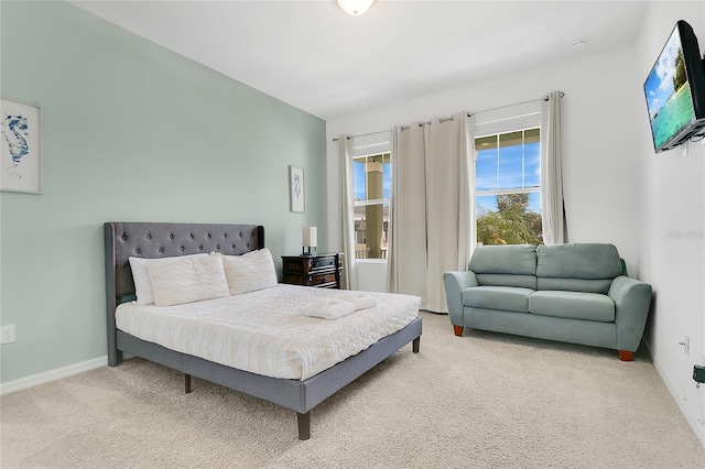 carpeted bedroom featuring baseboards