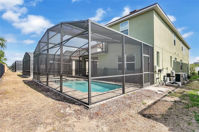 8951 Amelia Downs Trl, Kissimmee, FL 34747 - back of house with an outdoor pool, a lanai, a patio, and stucco siding